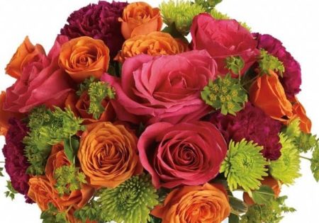This exciting bouquet includes hot pink roses, orange spray roses, green button spray chrysanthemums, purple carnations and bupleurum. Delivered in a glass bubble bowl. 